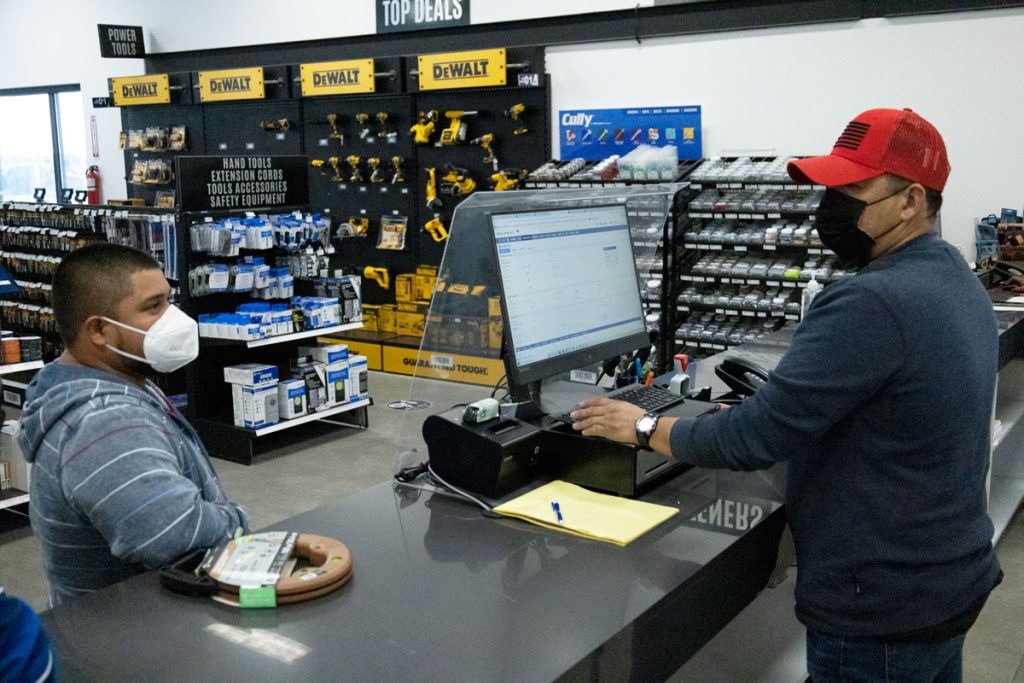 Buyer asking for help by man at RGV Electric Supply store.