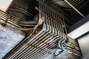 man using gloves to work with online electrical supply conduits